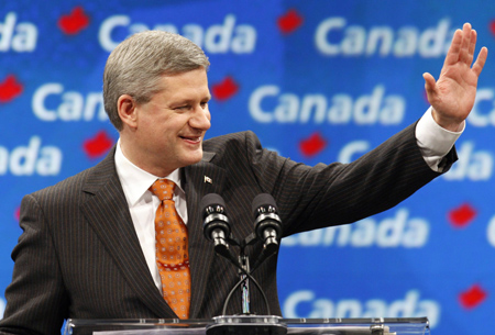 Conservative Party leader and Canadian Prime Minister Stephen Harper gestures to supporters at his election night headquarters in Calgary