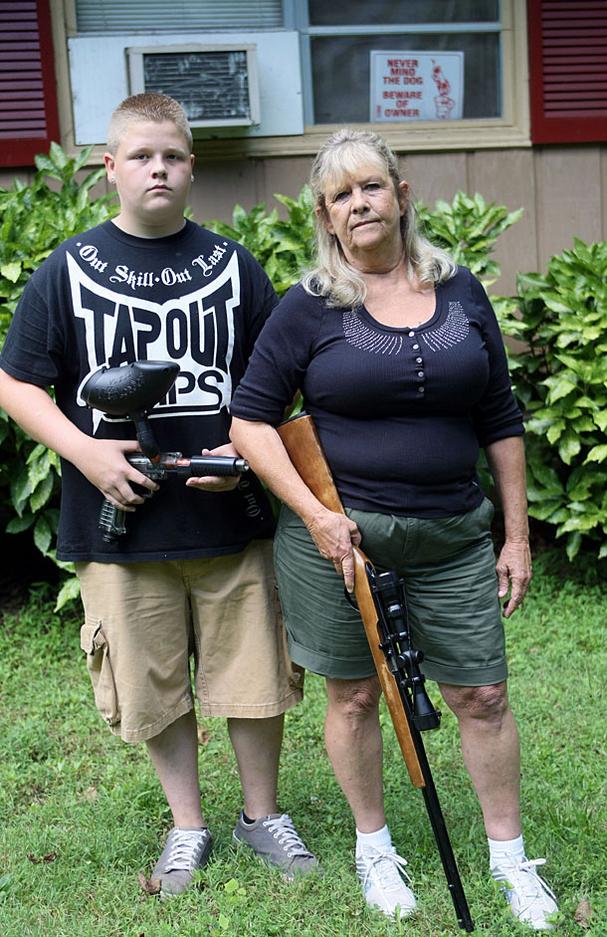 Janie Hood, with her 15-year-old grandson Jesse Nichols, says she carries a gun for protection because she is being harassed.