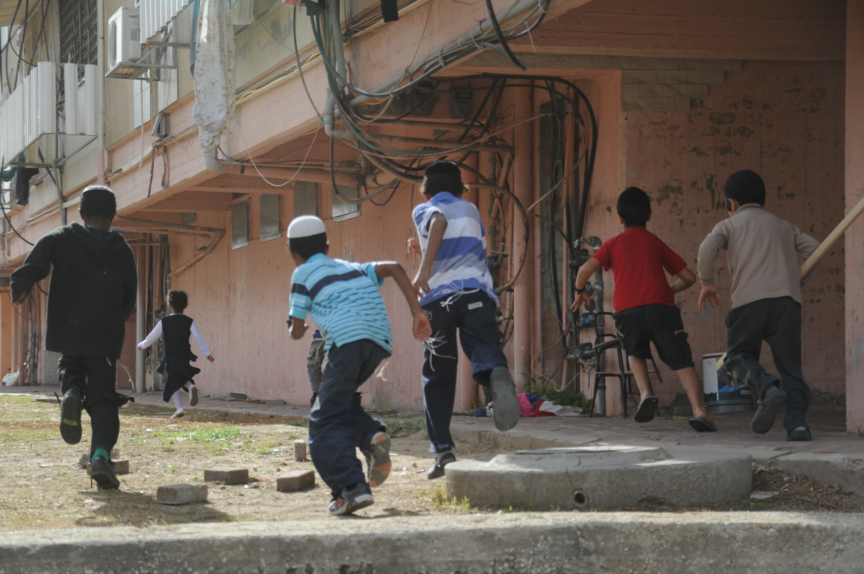 Children running for shelter in Kiryat Malachi as a rocket siren sounds. Two days earlier, three civilians were killed by a rocket strike in the town. November 16.