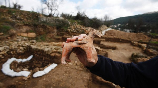 Excavation director Anna Eirikh displays a horse figurine.