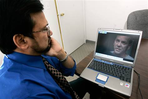 Sohail Mohammed, an immigration lawyer who represented detainees caught in the post-Sept. 11 furor, watches the Fox series ‘24’ at his office in Clifton, N.J. “Somewhere, some lunatic out there watching this will do something to an innocent American Muslim because he believes what he saw on TV,” Mohammed said.