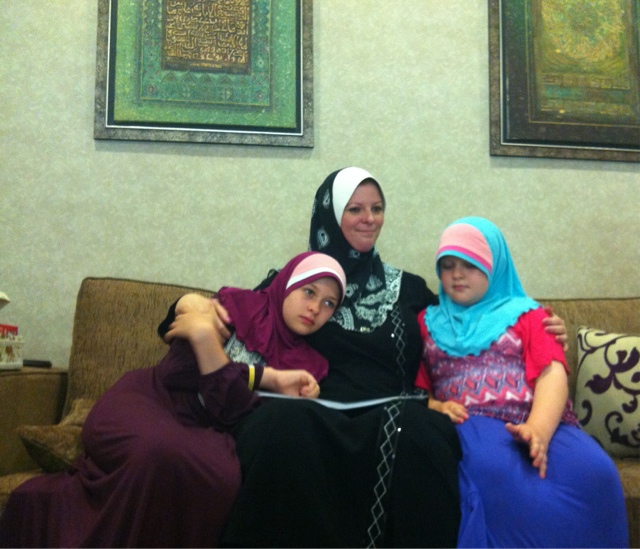 Booth with her two daughters who have been forced to become Muslim slaves like their mother