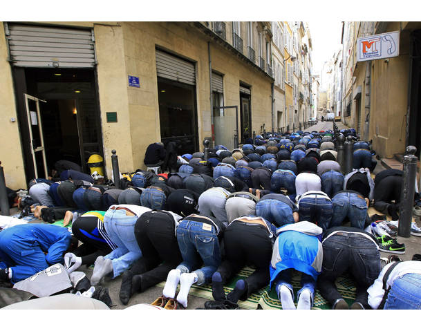 Muslims pray in the street during Friday prayers near the al-Quds mosque in Marseille