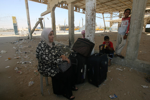 A Palestinian woman wates at the Rafah crossing with Egypt