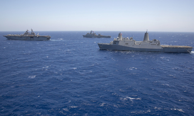 USS Kearsarge (LHD-3), left, leads the amphibious dock landing ship USS Carter Hall (LSD-50) and the amphibious transport dock ship USS San Antonio (LPD-17) on June 16, 2013.