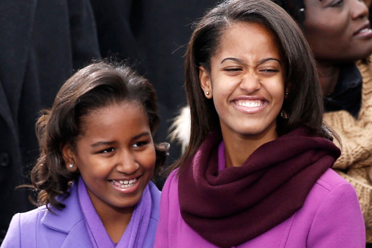 Malia and Sasha Obama daughters of U.S President Barck Obama smile before swearing-in ceremonies for U.S. President Obama on the West front of the U.S Capitol in Washington
