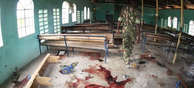 A Kenyan policeman at the site of a gun and grenade attack on a church, Garissa, northern Kenya, July 2012. 17 were killed in what is believed to be a reprisal for operations against al Qaeda-linked insurgents in Somalia. 