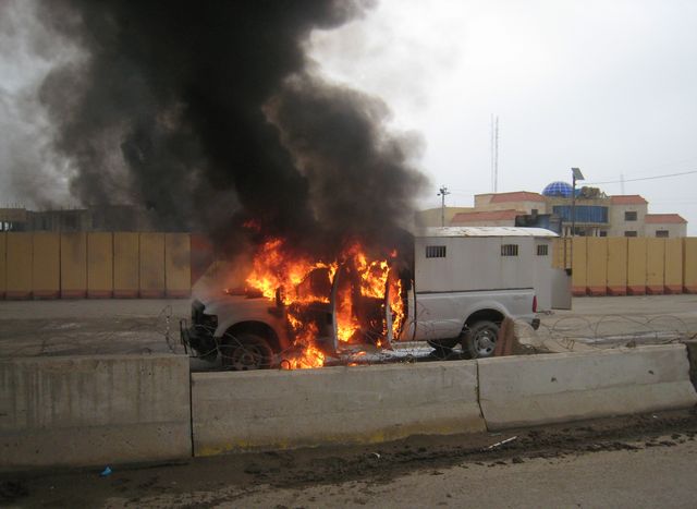 A police truck full of prisoners being transported was set afire by al Qaeda fighters after they freed prisoners in front of the main provincial government building, in Fallujah