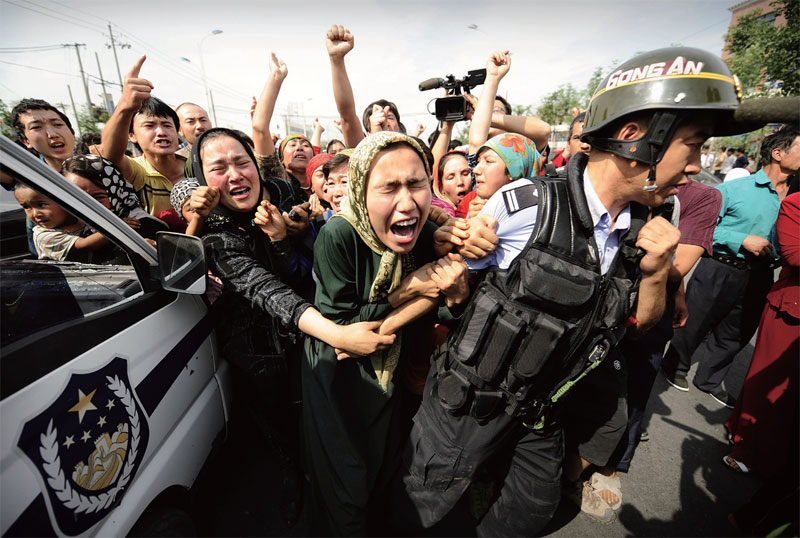 Uighur Muslim women clash with police