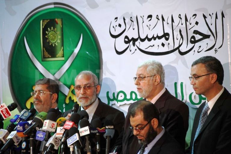 Mohammed Badie, second from left next to ousted president Mohamed Morsi