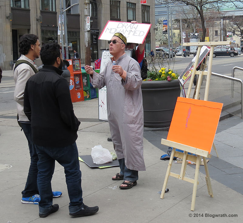 Eric Brazau talks with Muslims in front of the easel