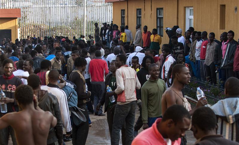 Would-be immigrants gather in the courtyard of a temporary immigrant holding center in Melilla