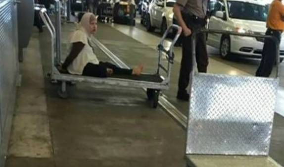 THE CUFFED BAGHEAD ON A BAGGAGE CART