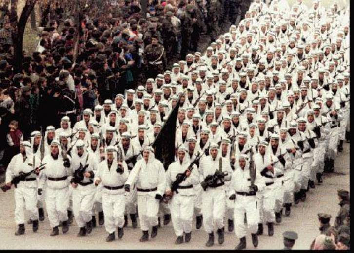 The Al-Qaeda-linked ‘El-Mujahedeen’ brigade of the Bosnian Muslim Army parading in downtown Zenica in central Bosnia in 1995, carrying the black flag of Islamic jihad