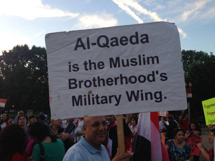 Posters held up by Egyptian Americans 