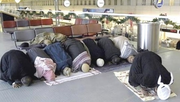 Muslims raising their asses to allah at airports scare other passengers