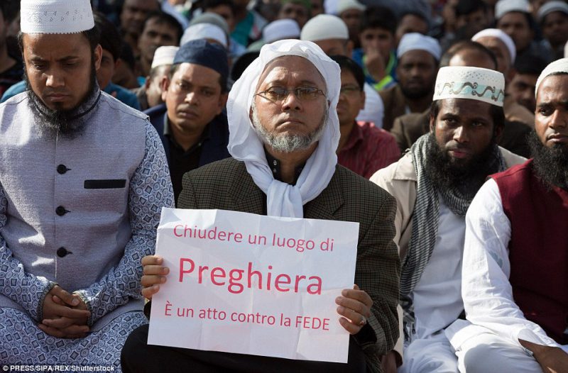 Muslim held up signs reading in Italian 'To close a place of worship is against faith' during the demonstration