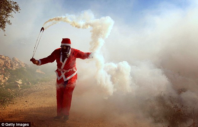 SANTA JIHAD! Muslim dressed in Father Christmas costume throws tear gas at Israeli security forces